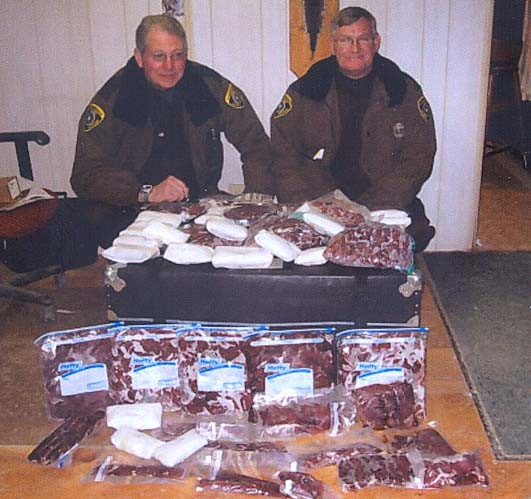 Sgt. Roy Cool and Conservation Officer Bob Waybright with venison confiscated from Jimmy Gillis of Barbour County, who pleaded guilty to seven wildlife law violations.