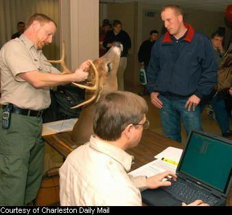 Randy Kelley reads measurement to Randy Tucker who enters data onto a computer form.